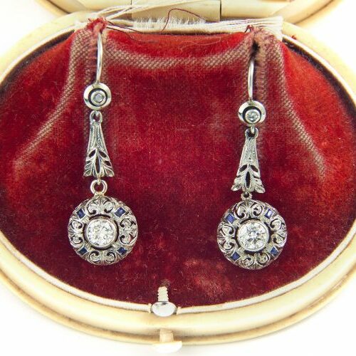 Orecchini pendenti in oro bianco recanti diamanti taglio antico di ct. 0,30 caduno ca. contornati da zaffiri carrè . Epoca anni '20