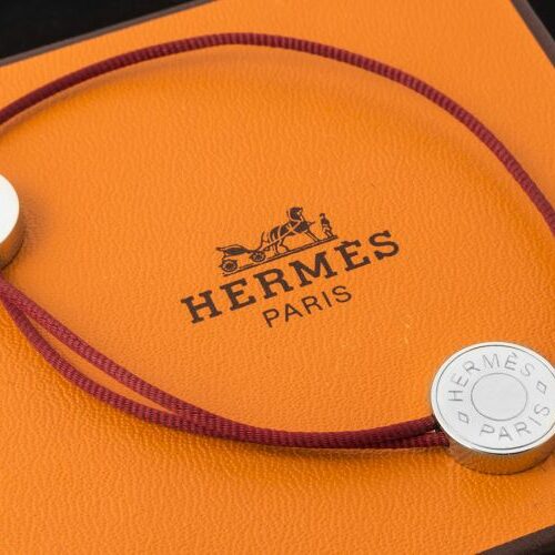 Bracciale in acciaio e cordino rosso. Hermès